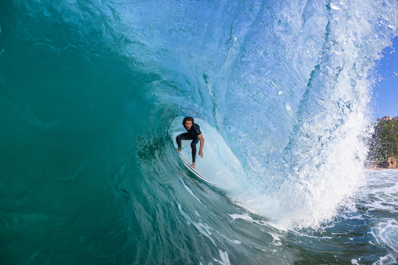 Surfer surfing hollow wave tube ride closeup up water action photo sequence.